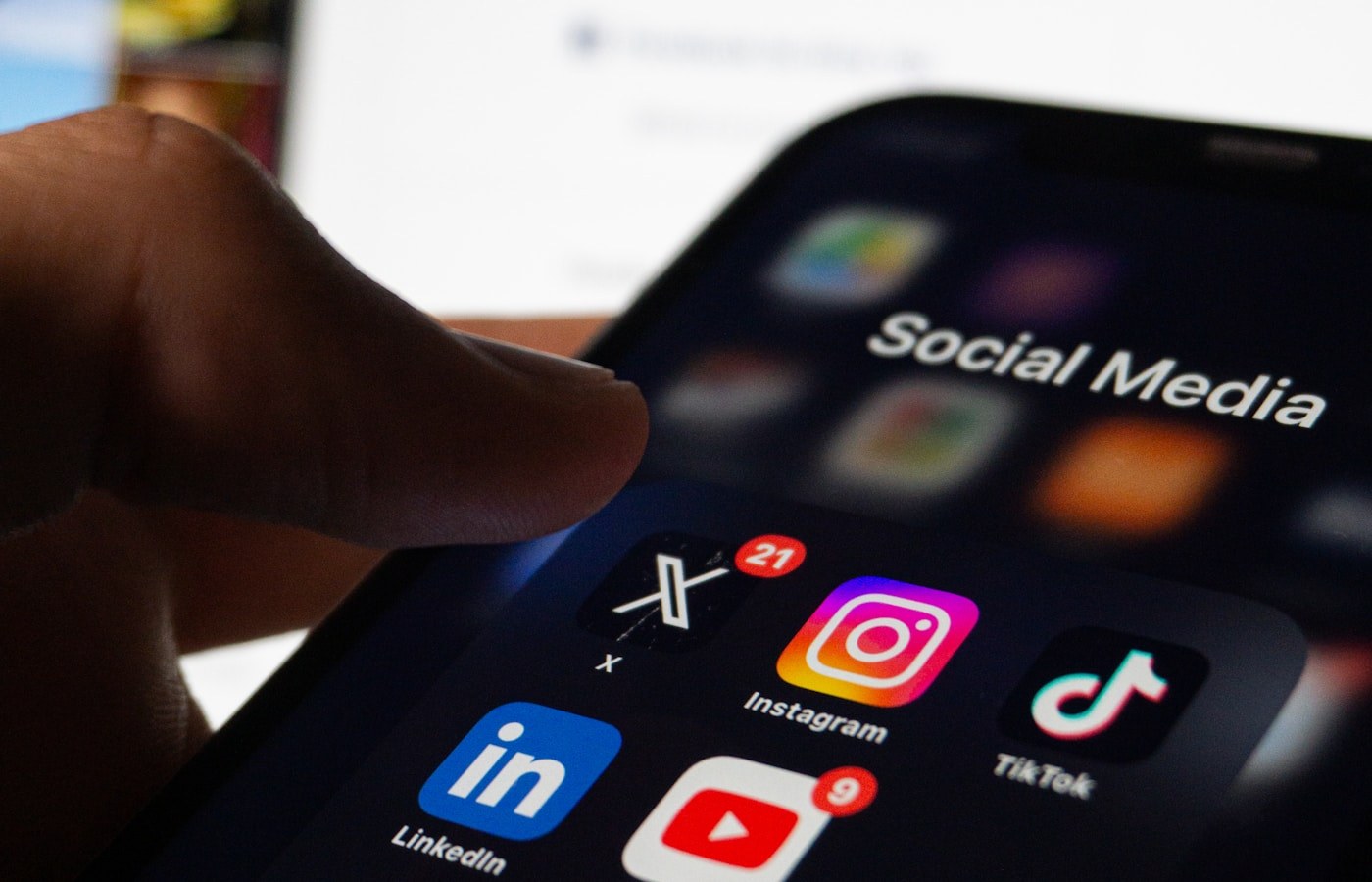 Close-up of a phone home screen showing social media apps