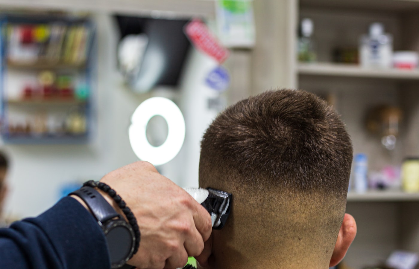 Barber cutting a repeat customer's hair — the kind of business a booking app helps most
