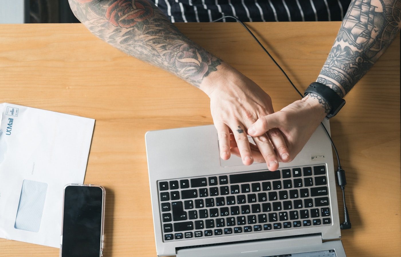 Small business owner working at a laptop, weighing up what a website should cost