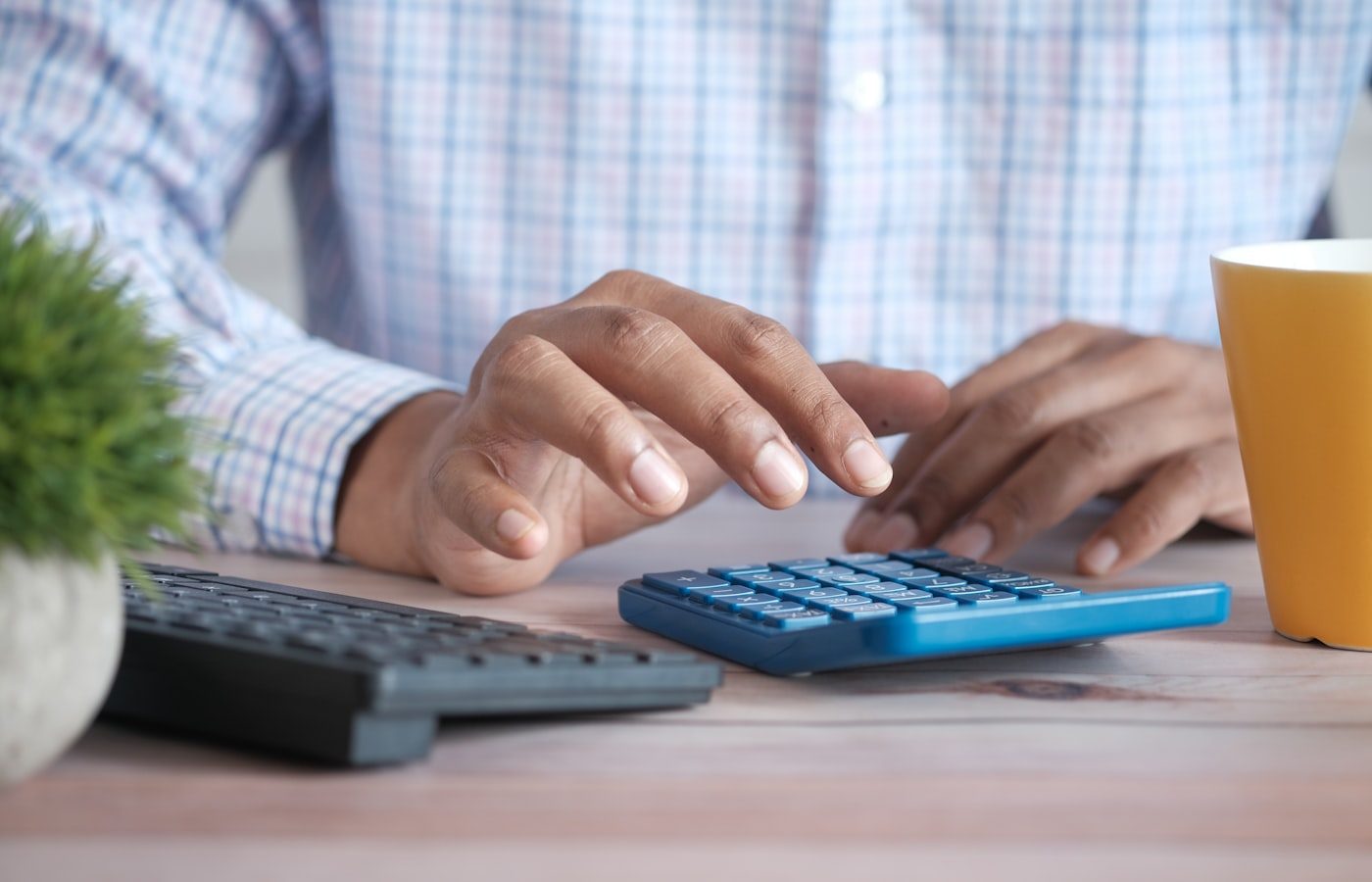 Running the numbers on a calculator at a desk
