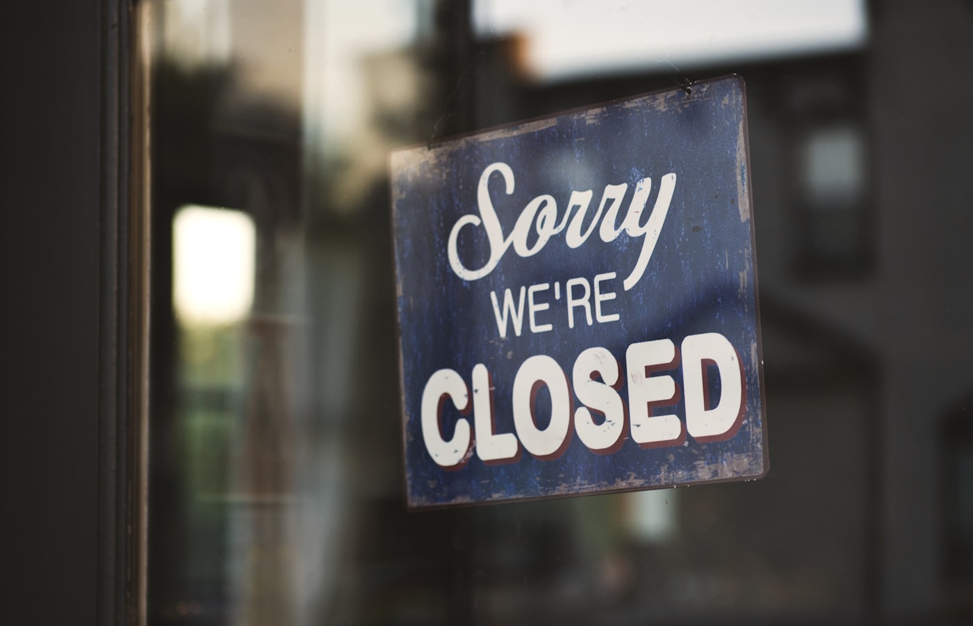 A closed sign on a shop door, like a neglected website with broken links