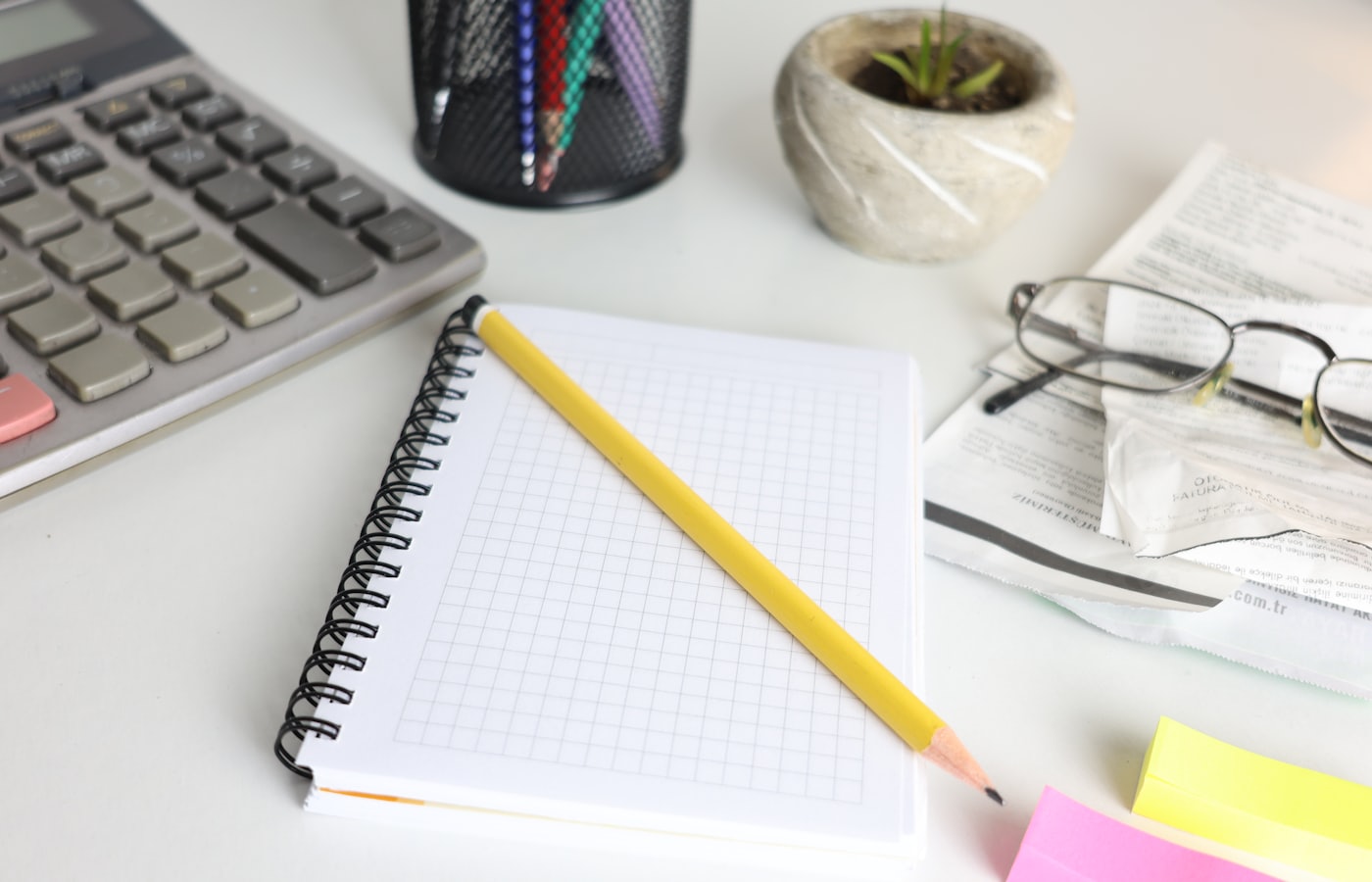 Calculator and notebook on a desk — counting the real cost of a website